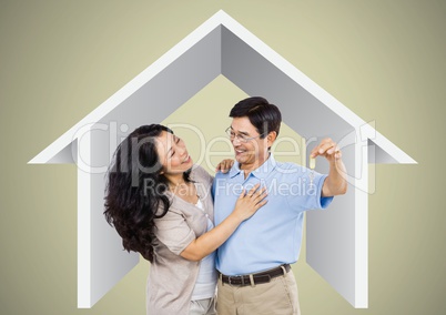 Couple Holding key with house icon in front of vignette