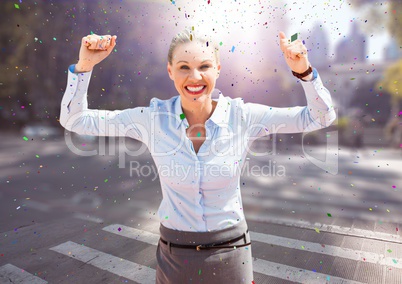 Business woman hands in air on blurry street with flares and confetti