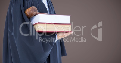 Judge mid section with books and gavel against brown background