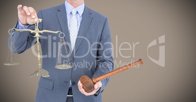 Male judge mid section with gavel and scales against light brown background