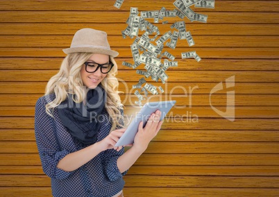 texting money. hipster with hat and glasses with tablet,  money coming up from tablet.