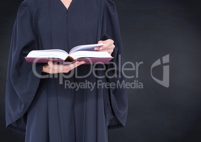 Female judge mid section with open book against navy chalkboard