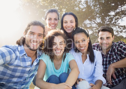 Group of friends smiling in blurry park