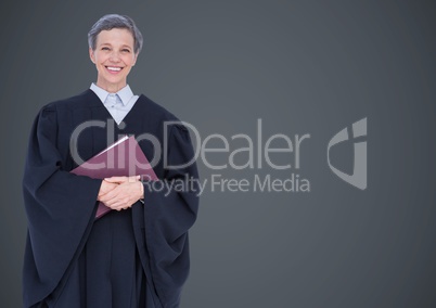 Female judge with book against grey wall