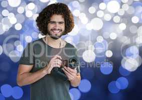photographer with camera on hands. Blue and white bokeh background