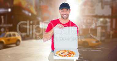 Delivery man with pizza against blurry street with flares