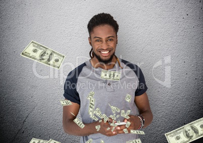 texting money. Young man with phone. Money coming up from phone