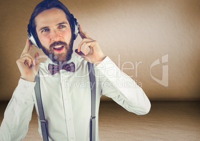 Millennial man with headphones in brown rooms