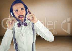 Millennial man with headphones in brown rooms