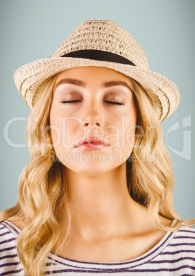 Close up of millennial woman with eyes closed against grey background