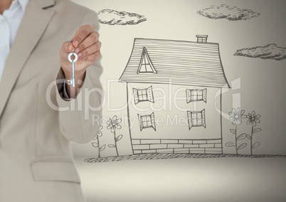 Hand Holding key with house drawing in front of vignette