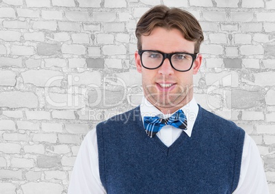 Nerd man in blue vest against white brick wall