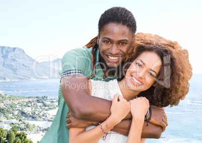 Millennial couple against blurry coastline