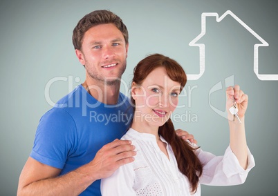 Couple Holding key with house icon in front of vignette