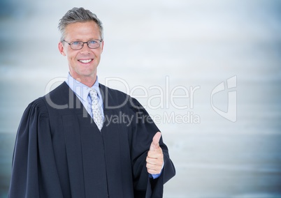 Male judge thumbs up against blurry blue wood panel