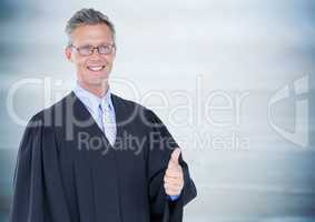 Male judge thumbs up against blurry blue wood panel