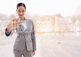 Woman Holding keys in front of houses