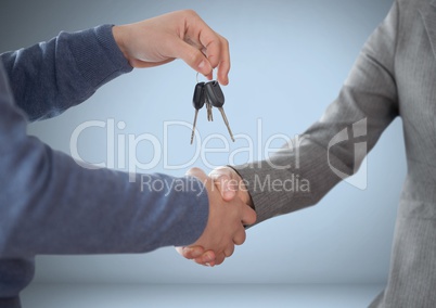 Hands Holding key in front of vignette with handshake