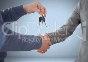Hands Holding key in front of vignette with handshake