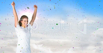 Woman cheering against sunny sky and confetti