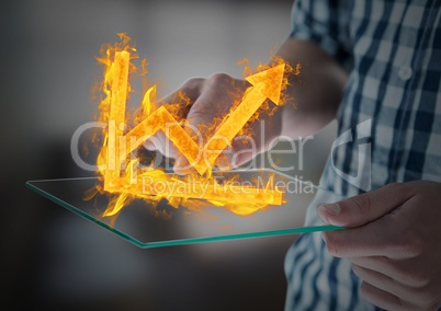 hands with device with graph fire icon over. Blurred office background
