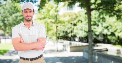 Delivery man arms folded against blurry campus