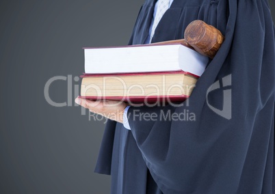 Judge mid section with books and gavel against grey background