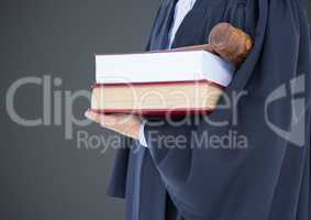 Judge mid section with books and gavel against grey background