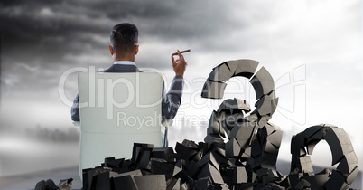 Broken concrete stone with Question symbol and businessman in seat in cityscape