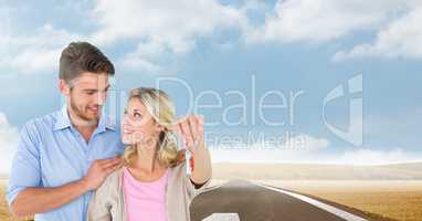 Couple  Holding key in front of road