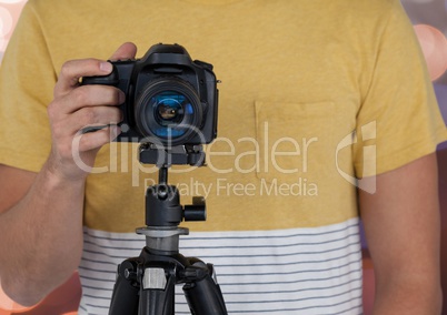 photographer with camera on tripod. Bokeh background