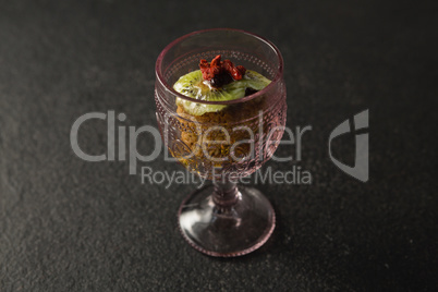 Dried fruits and granola bar in glass