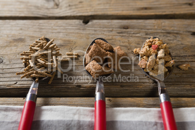 Three spoons with various breakfast cereals