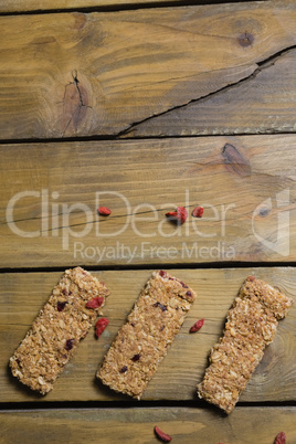 Three granola bars arranged on wooden table