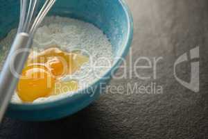 Close up of flour and egg in container