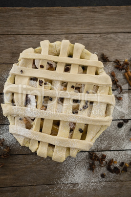 Directly above shot of apple pie in baking pan by spices