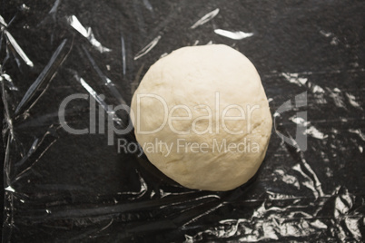 Dough on plastic wrap