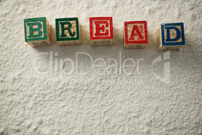 Bread text made with wooden blocks on flour