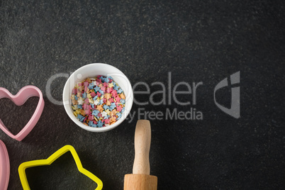 Overhead view of candies in bowl by pastry cutter