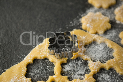 High angle view of flower shape mould on dough