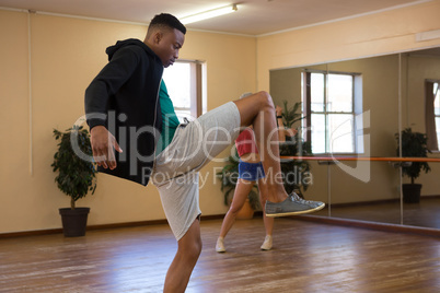 Side view of dancer practicing in studio