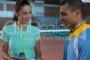 Coach talking with male volleyball player