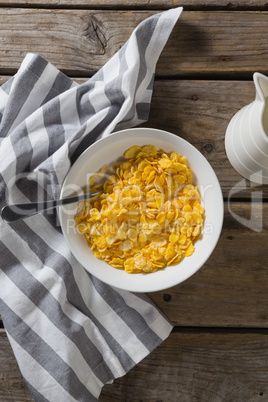 Bowl of wheaties cereal and spoon with napkin