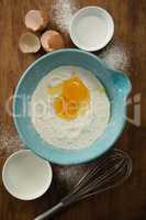 Overhead view of egg and flour in bowl