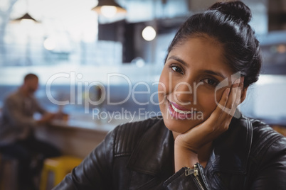 Portrait of smiling woman with friend in background