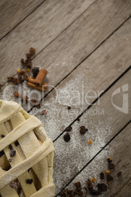 Cropped image of apple pie with spices on table