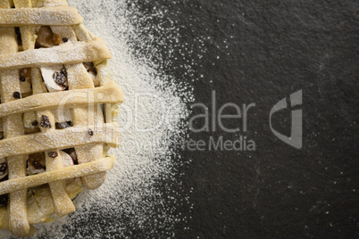 Close up of apple pie amidst flour