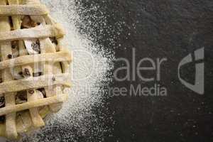 Close up of apple pie amidst flour