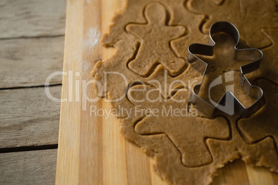 High angle view of gingerbread man pastry cutter on dough