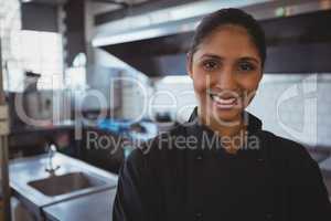 Portrait of smiling waitress in cafe
